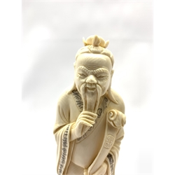 Japanese Meiji ivory Okimono of a Fisherman and young boy, H35.5cm together with a similar age Japanese ivory Okimono of a Sage, standing in long robe holding a ruyi scpetre on hardwood stand (2)