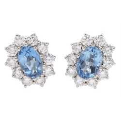 Pair of 18ct white gold oval aquamarine and round brilliant cut diamond cluster stud earrings, stamped 750, total aquamarine weight approx 1.55 carat, total diamond weight approx 0.90 carat
