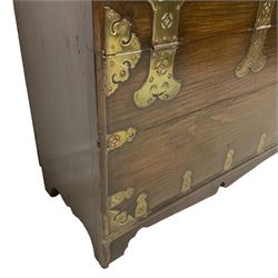 19th century Korean brass bound elm morijang or cabinet, fall-front cupboard enclosing three small drawers and large compartment, the brass fittings pierced with geometric patterns, with heavy brass lock in the form of a fish