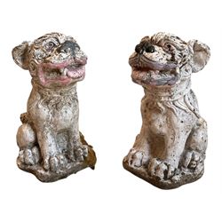 Pair of cast stone garden ornaments in for form of Dogs of Fo, with cream and polychrome painted decoration