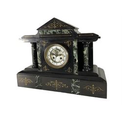Late 19th century - 8-day Belgium slate and marble mantle clock, with a gable pediment, inlaid green variegated marble panels, gilt incised decoration and recessed circular columns, French movement with a two part enamel dial, Roman numerals, visible Brocot deadbeat escapement and steel fleur di Lis hands.
With pendulum.
