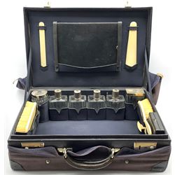 French Leather Dressing Case with glass and silver mounted jars and bottles, mirror, ivory backed brushes etc
