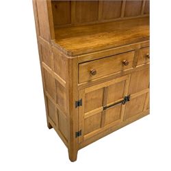 Rabbitman - adzed oak dresser, raised two tier plate rack over three drawers and three panelled cupboards, with wrought metal hinges and fittings, carved with rabbit signature, by Peter Heap of Wetwang 