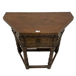 17th century design oak Credence side table, hinged top with rear gate-leg, canted front with strapwork decoration and central drawer, mounted by half turned mounts, on turned supports with rusticated lower halves united by moulded stretchers