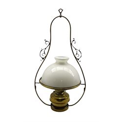Victorian brass hanging oil lamp having a brass oil reservoir, white opaque glass domed shade and outer scroll pendant hanging fitting, H91cm overall
