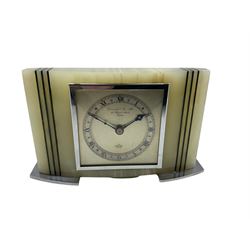 A 1950’s rectangular white Onyx cased mantle clock retailed by Gerrard & Son, London, with a sheet metal dial and square chrome bezel, silvered chapter ring with Roman numerals, minute track and steel hands, eight-day spring driven movement by Elliot & Co London. Wound and set from the rear.