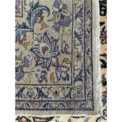 Persian ivory ground carpet, overall floral design with central medallion, the field decorated with scrolling branches and stylised plant motifs, repeating border within guard stripes
