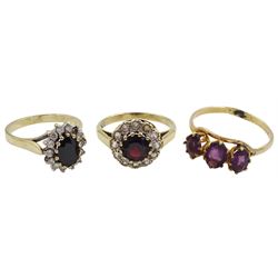 Gold three stone amethyst ring, gold garnet and cubic zirconia cluster ring and one other gold stone set ring