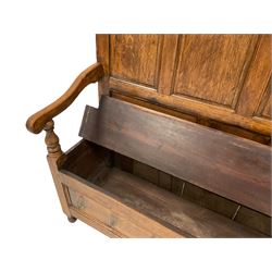 19th century oak settle bench, the high back with four arch shaped panels, scrolled arm terminals with turned arm supports, rectangular seat with hinged lid concealing compartment, the base with two panels to the front with moulded edges