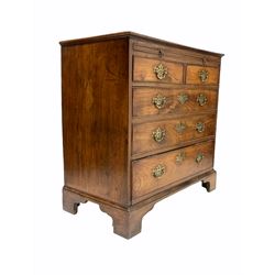 George III mahogany bachelors chest, cross banded top and fitted with brushing slide above two short and three long drawers, raised on bracket supports W85cm, H84cm, D46cm
