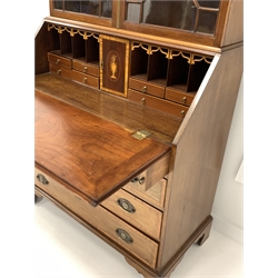 George III mahogany bureau bookcase, swan neck pediment with paterea inlay over astragal glazed doors enclosing three adjustable shelves, the cross banded and string inlaid fall front revealing well fitted interior, four drawers under, raised on shaped bracket supports, W99cm, H236cm, D50cm