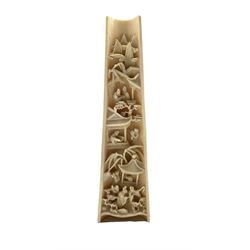 19th century Chinese ivory wrist rest intricately carved with figures and buildings, the reverse with two figures on a path L22cm