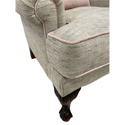Traditionally shaped wingback armchair, hardwood framed with fan curved back, upholstered in woven Herringbone fabric in pale grey with pink piping, on ball and claw carved feet, with contrasting pink scatter cushion 