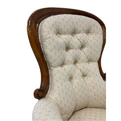 19th century walnut spoon-back armchair, moulded upper frame with scroll carved terminals, upholstered in buttoned ivory fan patterned fabric, on turned front supports with brass and ceramic castors