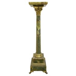 19th century onyx torchere, the square top above a gilt metal Corinthian capital, plain tapering column on stepped gilt metal square base, H111cm 
