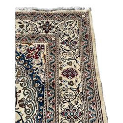 Perisan Kashan ivory ground rug, the field decorated with interlacing branches and stylised plant motifs, central floral medallion, repeating border decorated with scrolling and flower head motifs