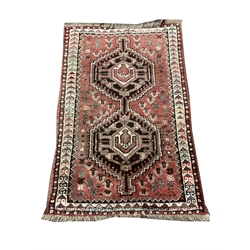 Persian hand knotted red ground rug with double pole medallion, field decorated with stylised motifs, dog tooth inner border, 134cm x 89cm