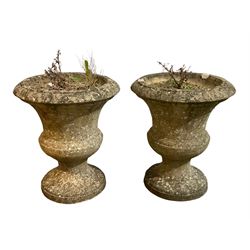Pair of weathered cast stone garden urns of Campana form