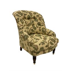 Parker Knoll - tub chair upholstered in beige, buttoned back floral fabric, raised on turned supports 