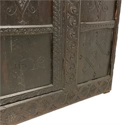 17th century and later carved oak cupboard, rectangular top with moulded edge over a frieze carved with s-scrolls and palmette motifs, the panelled front carved with foliate lozenges and engraved with Jacobean 'J I' and '1629' lettering, flanked by uprights carved with interlocking guilloche patterns, fitted with single panelled door enclosing shelf, on skirted base