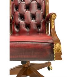 Barnini Oseo - 'Reggenza' swivel office chair, scrolled high back, upholstered in buttoned oxblood leather with gilt studwork, arm terminals decorated with gilt foliate mounts, on castors