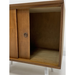 Mid century Danish teak PS systems cabinet, with two sliding doors, raised on tapered white supports, W71cm