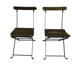 Pair of vintage folding garden chairs with metal frames and slatted wooden seats