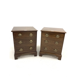 Pair of mahogany bedsides, with hinged tops revealing plain interiors, over three faux drawers, raised on shaped bracket supports, W39m