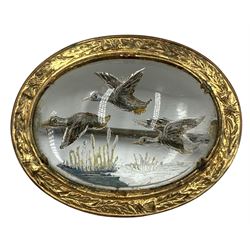 Essex crystal oval Mizpah brooch reverse painted with ducks in flight in a gilt metal frame