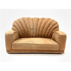Early 20th century Art Deco shell back two seat sofa, upholstered in salmon herringbone fabric, raised on metal castors, W150cm, H82cm, D95cm