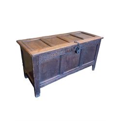 18th century oak coffer, the hinged lifting lid over carved frieze with inscription 'I H' over three panelled base, raised on stile supports 