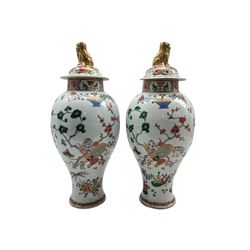 Pair of 19th century Samson of Paris armorial vases and covers decorated in the Chinese manner with Dog of Fo lifts, coat of arms and flowers etc H40cm 