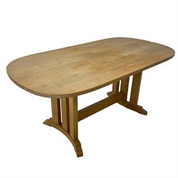 Solid light oak dining table, rounded rectangular top on a series of upright supports, curved sledge feet