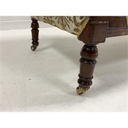 Late Victorian walnut chaise longue, with scroll ends and incised decoration, and carving to crest rail, upholstered in scrolling antique gold and green foliate pattern on a complimentary ground, raised on turned supports terminating in ceramic castors with brass mountings, L180cm