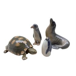 Four Royal Copenhagen porcelain animals comprising a Sea Lion no. 1441 and Penguin looking up no. 3003 both designed by Theodor Madsen, Penguin no. 1283 designed by Anna Trap and Tortoise no. 552 (4)