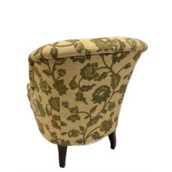 Parker Knoll - tub chair upholstered in beige, buttoned back floral fabric, raised on turned supports 