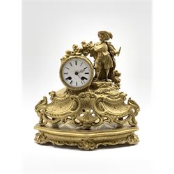 Late 19th century gilt metal figural mantel clock, the case surmounted by an artist flanking  a white enamel dial with Roman chapter ring, on a giltwood base decorated with conforming floral scrolls centred by cartouche W33cm