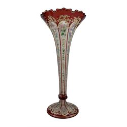 19th century Bohemian ruby flashed cut glass trumpet vase, the hexagonal frosted stem  enamelled with vertilinear floral decoration and heightened in gilt, H33cm