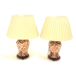  Pair of Chinese Imari style baluster form table lamps, decorated with panels of Dog of Fo on hardwood bases with pleated shades, H76cm overall  