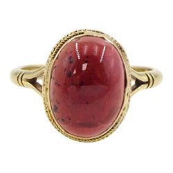 Gold single stone oval cabochon garnet ring, stamped 9ct