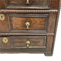 17th century Jacobean oak chest, rectangular moulded edge over four drawers with panelled sides, the facias painted with scrolling floral decoration and faux panel moulded edge, flanked by applied carved beading, raised on stile feet