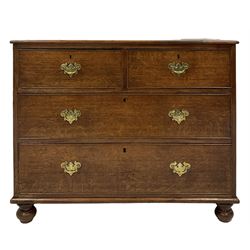 Early 19th century oak chest of drawers, fitted with two short and two long drawers, raised on turned bun feet