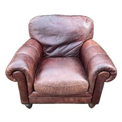 Single armchair upholstered in brown leather, traditional shape with rolled arms, on turned feet