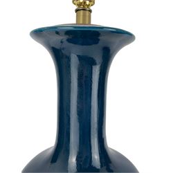 Pair of Chinese teal glazed table lamps, each of bottle form, raised upon circular hardwood bases, H43cm excluding fitting