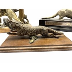 Silver plated model of an otter on wooden base with presentation inscription dated 1953 L27cm, a cold painted spelter model of a fox with a pheasant on oak wall panel L23cm and a painted spelter table lighter with a gun dog and pheasant