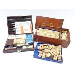 Chinese Mahjong set with bamboo tiles in wooden box and a modern travelling games set